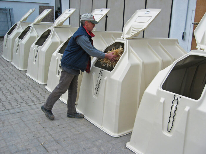 Preparación de la camada en la caseta para terneros de Calf-Tel a través de la compuerta de ventilación trasera