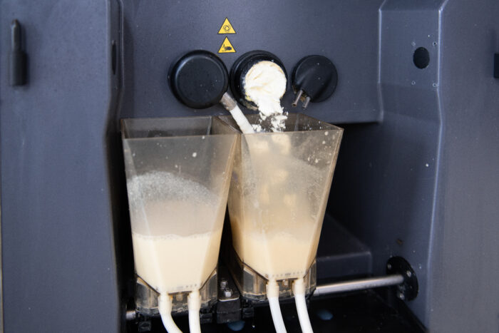 This detail picture shows two mixing bowls of the CalfExpert. Milk replacer powder is added to the whole milk.